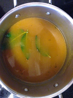 chicken broth and bay leaves simmering