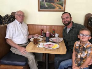 Logan Wilson with his father and son eating breakfast