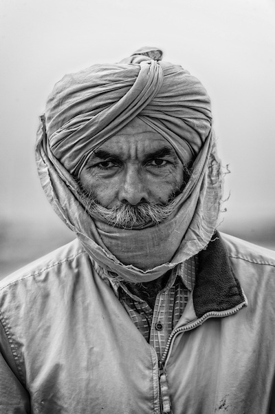 portrait of rice farmer with face and head covered