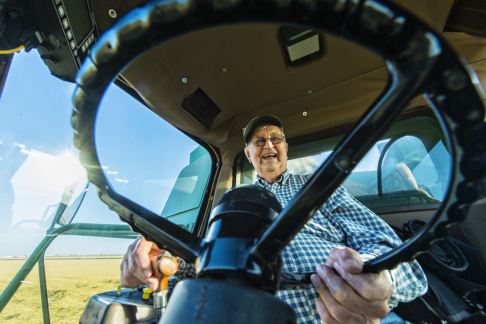 rice farmer driving harvester