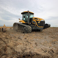 tractor doing fieldwork in rice field