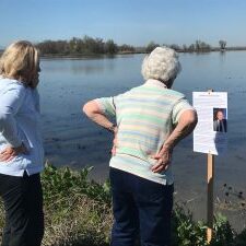 women reading dedication sign